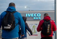 Zaměstnanci vcházející do firmy Iveco po více než měsíční odstávce.